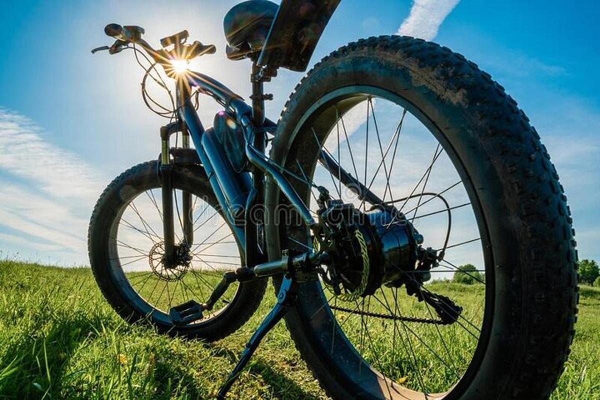a bike parked in the grass in a field