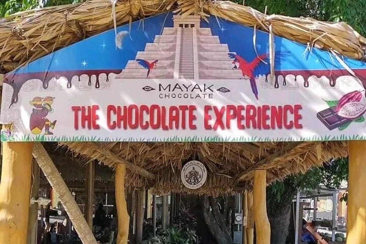 a sign for the chocolate experience at a restaurant