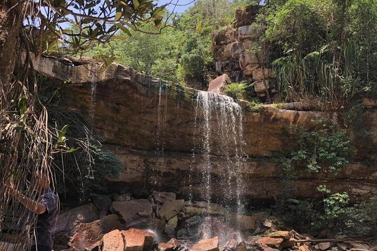 a person standing in front of a waterfall