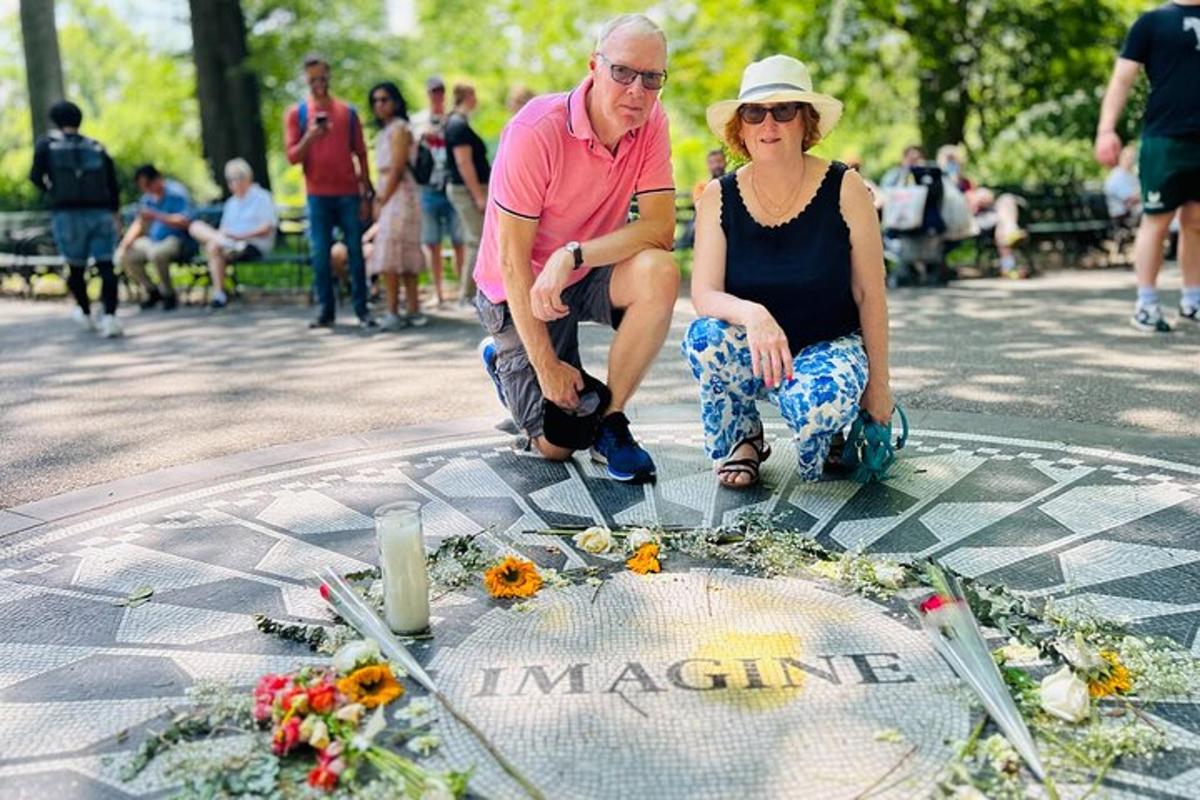 a man and a woman sitting in front of a fountain with flowers