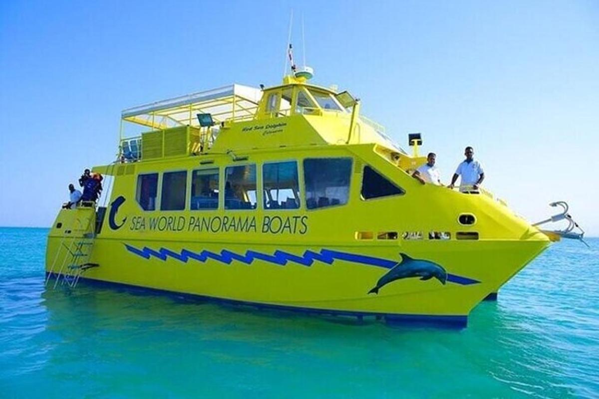 a yellow boat in the water with people on it