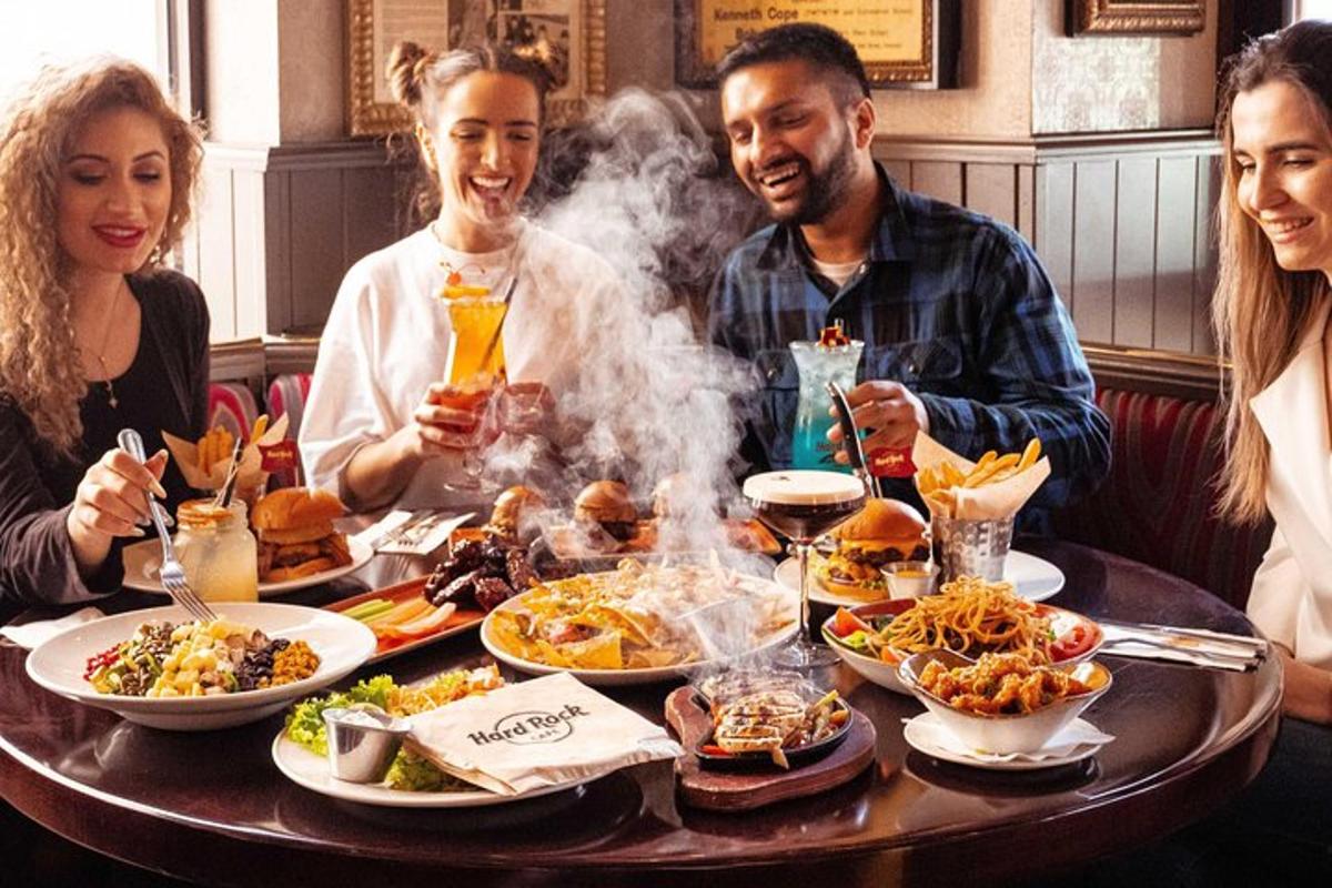 a group of people sitting around a table with food