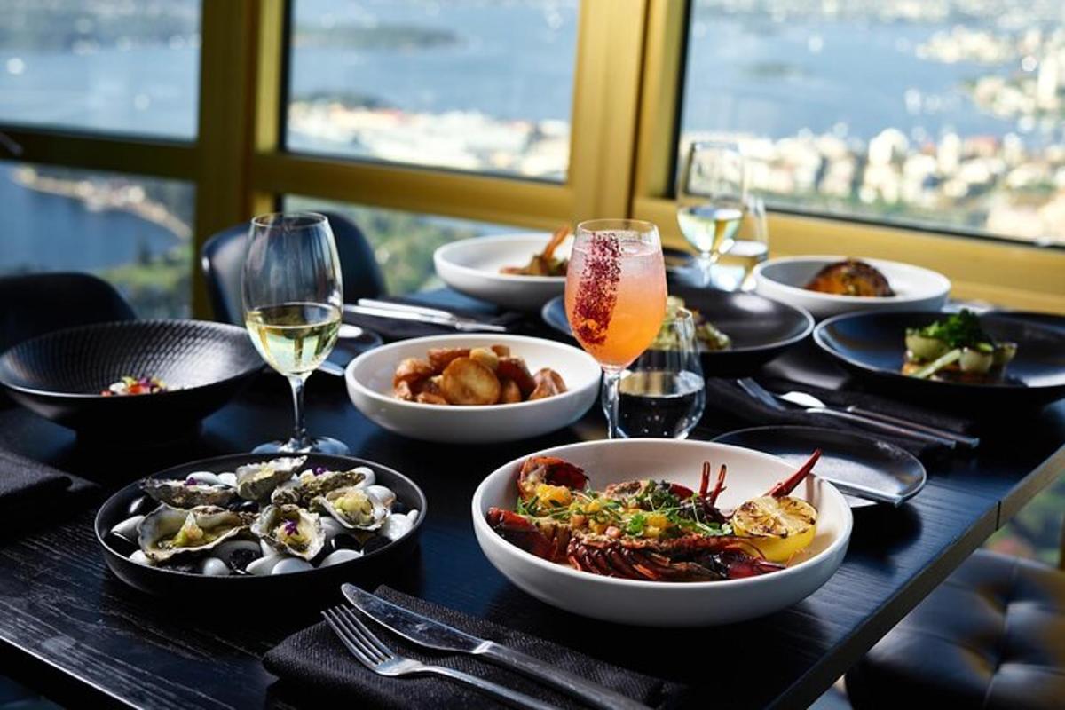 a table with plates of food and glasses of wine