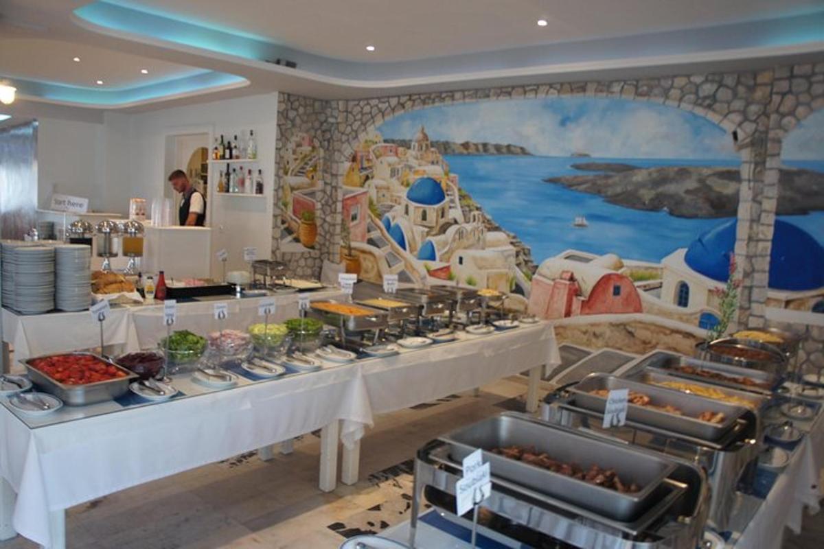 a buffet line in a restaurant with a mural