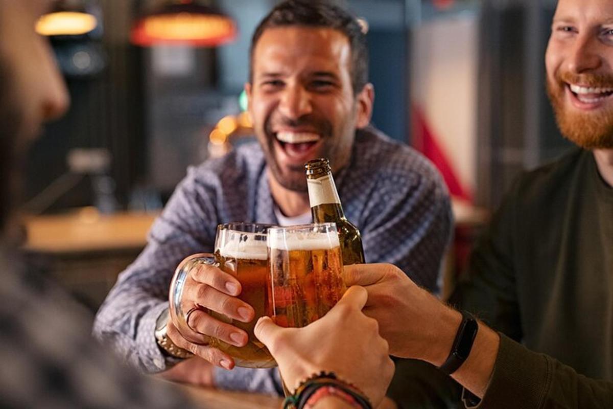 a group of people holding glasses of beer