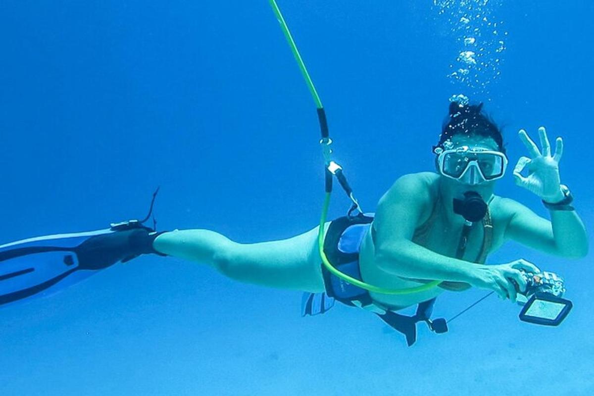 a diver in the water with a cell phone