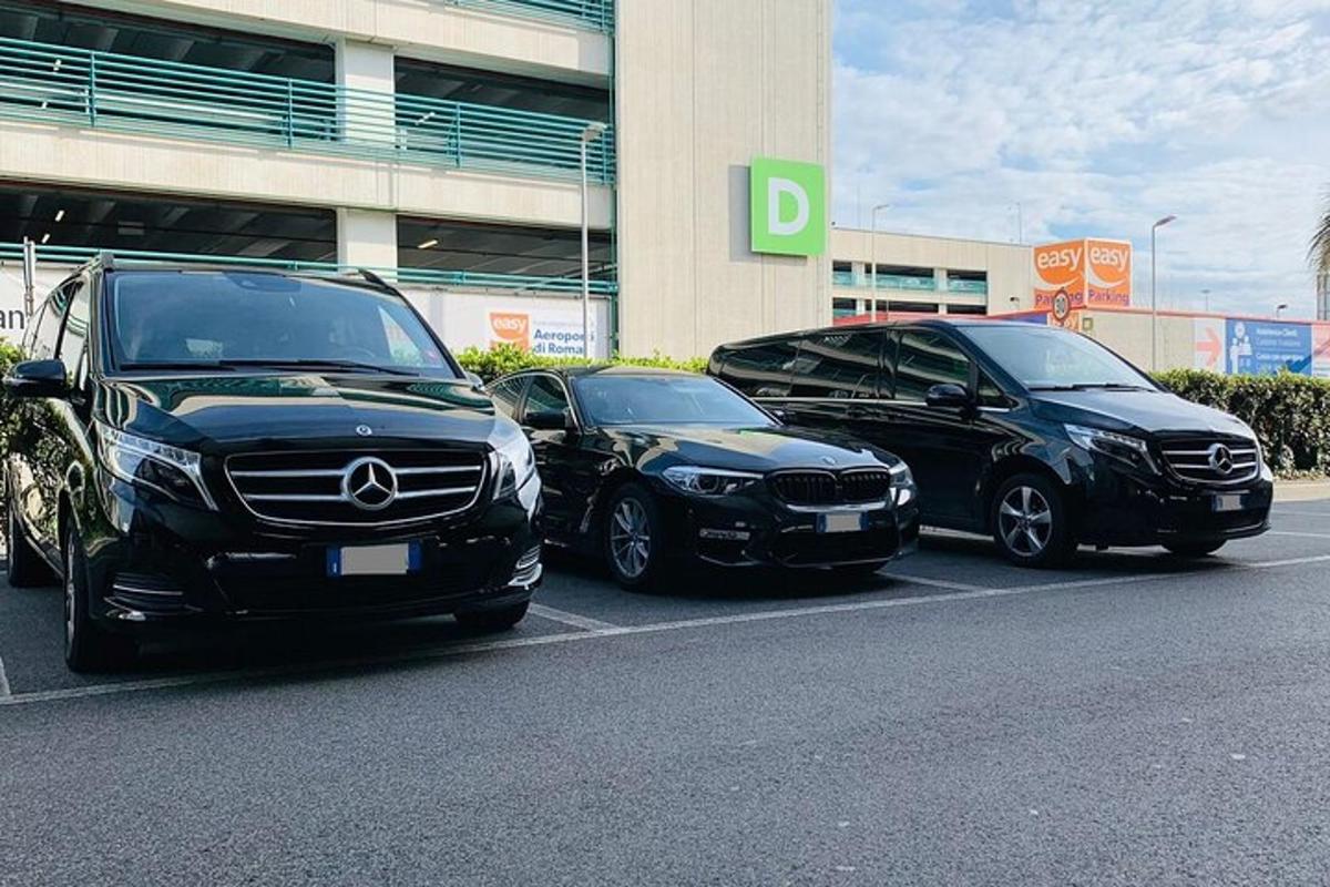 three cars parked in a parking lot in front of a building