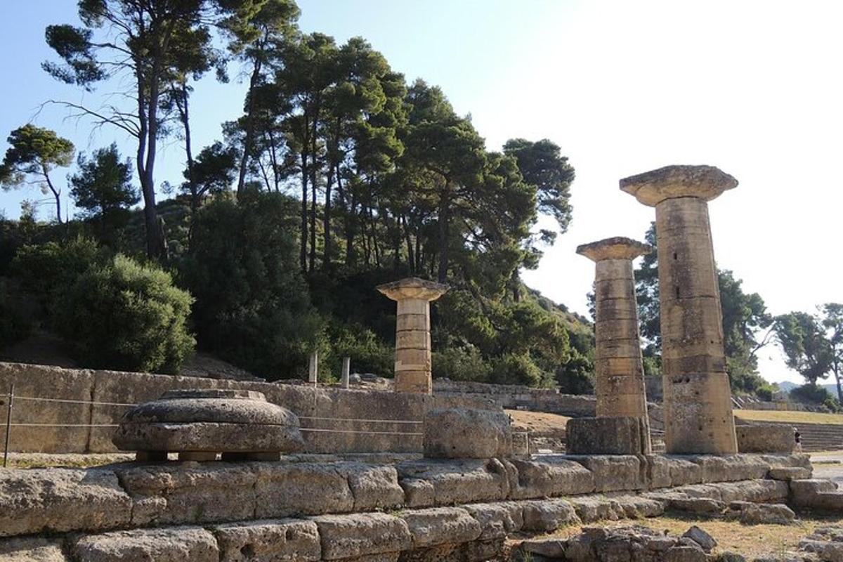 Δύο κολώνες σε πέτρινο τοίχο με δέντρα στο φόντο