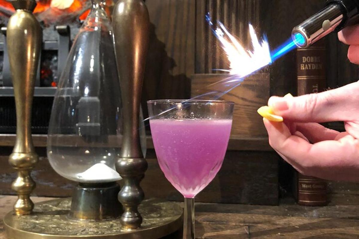 a person is lighting a sparkler in a drink