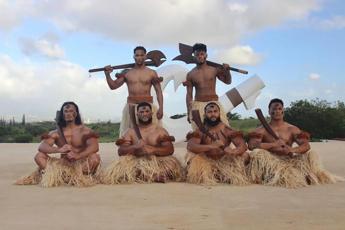 a group of men posing for a picture on the beach
