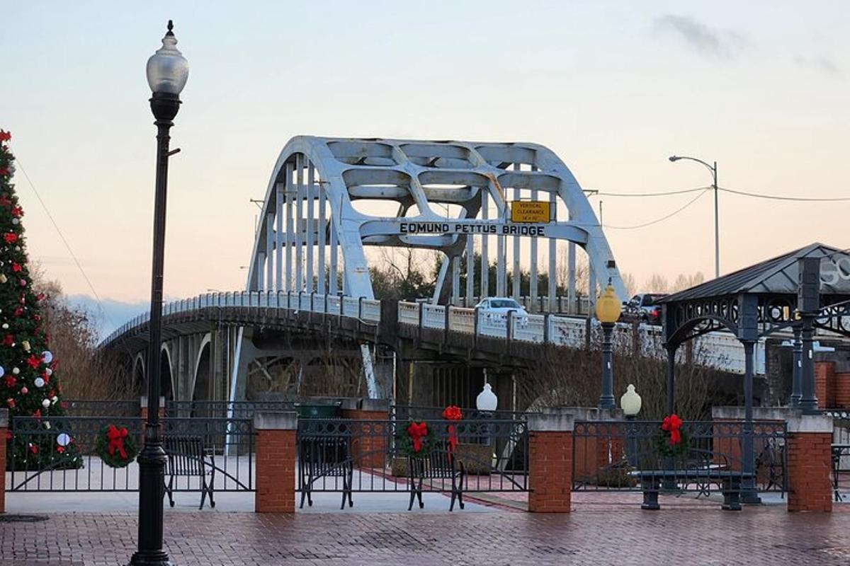a bridge with a christmas tree in front of it