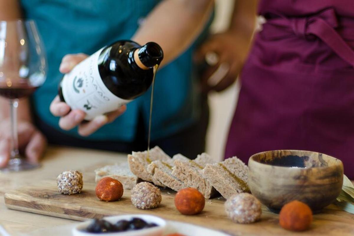 a person holding a bottle of wine and some food