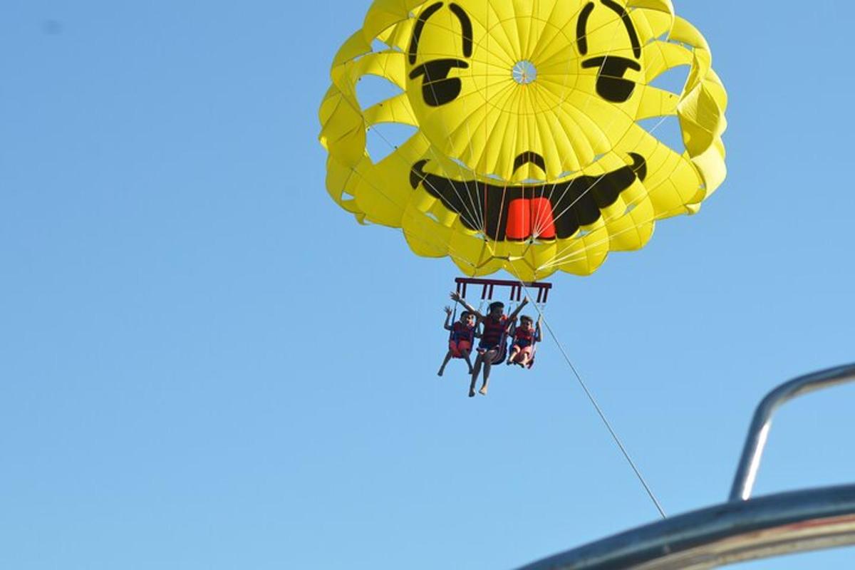 a hot air balloon with people hanging from it