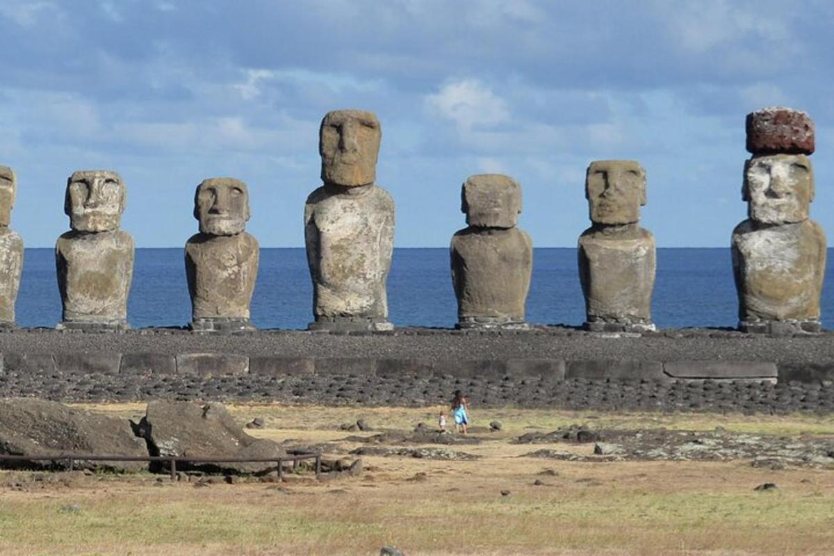 a group of mexican statues in front of the ocean