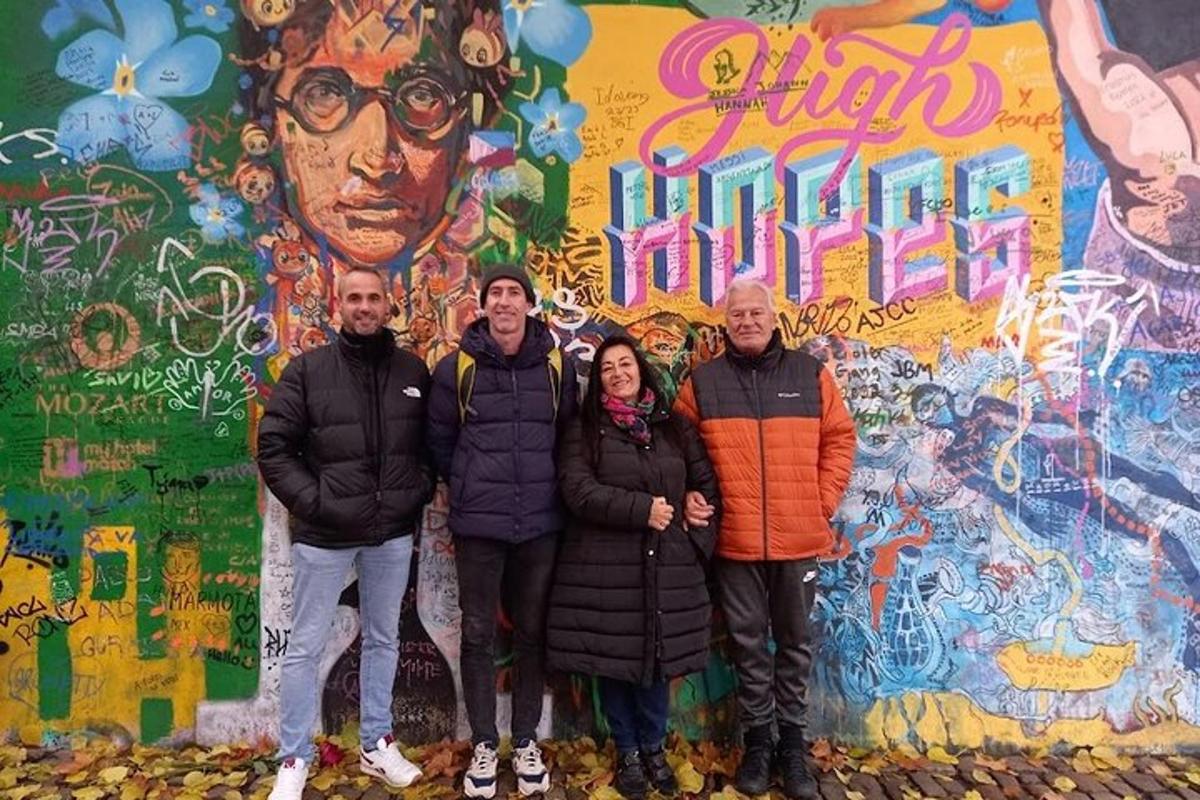 a group of people standing in front of a wall with graffiti