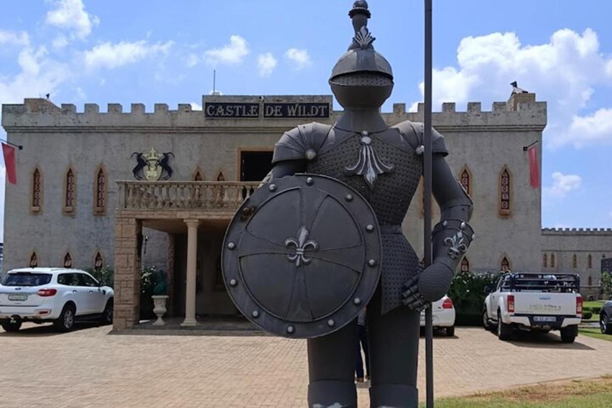 una statua di un uomo che tiene un orologio davanti a un edificio