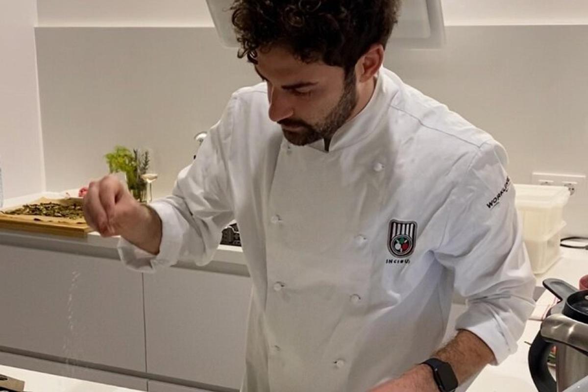 uno chef in piedi in cucina che prepara il cibo