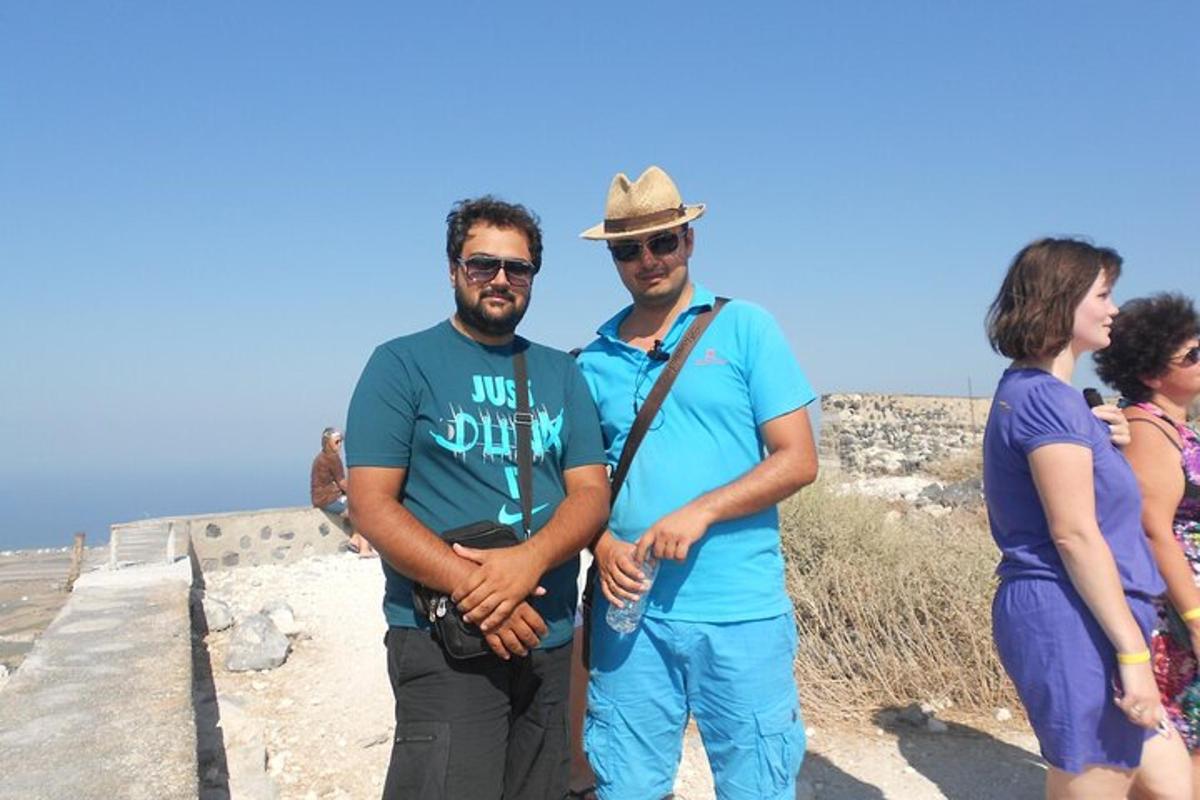 a group of people standing on the top of a wall