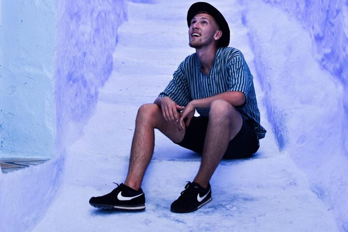 a man is sitting on the floor in a skate park