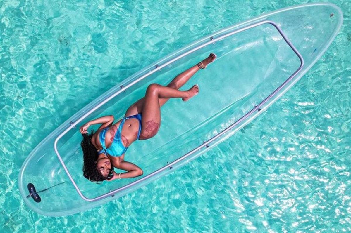 a woman laying on a paddle board in the water