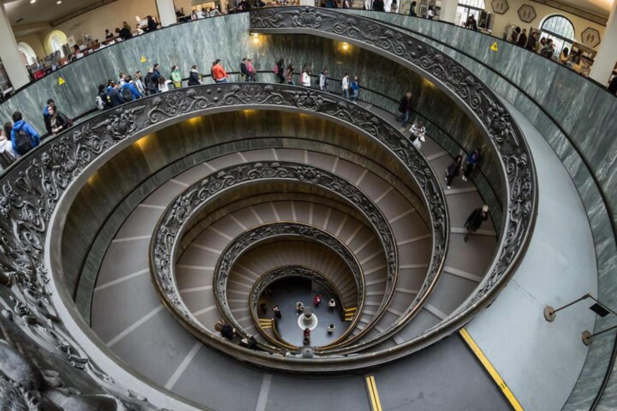 a spiral staircase in a building with a crowd of people
