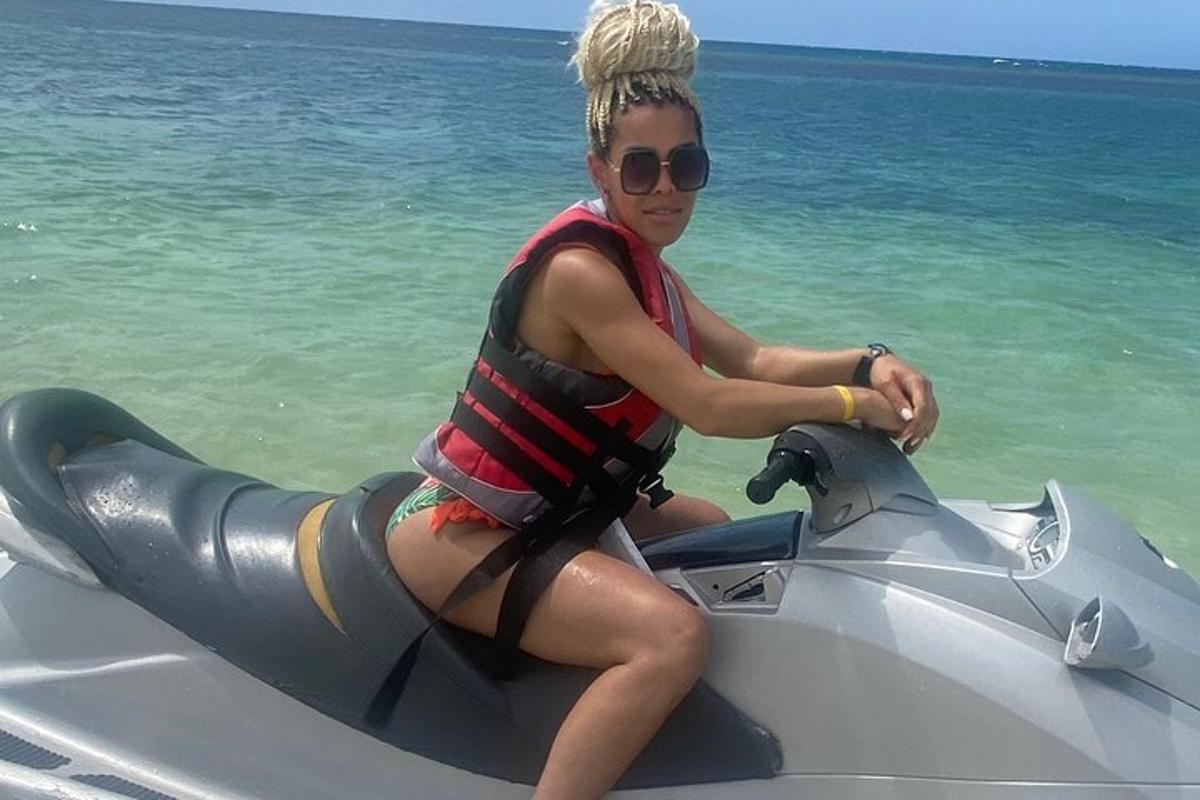 Una mujer sentada en una moto acuática en el agua