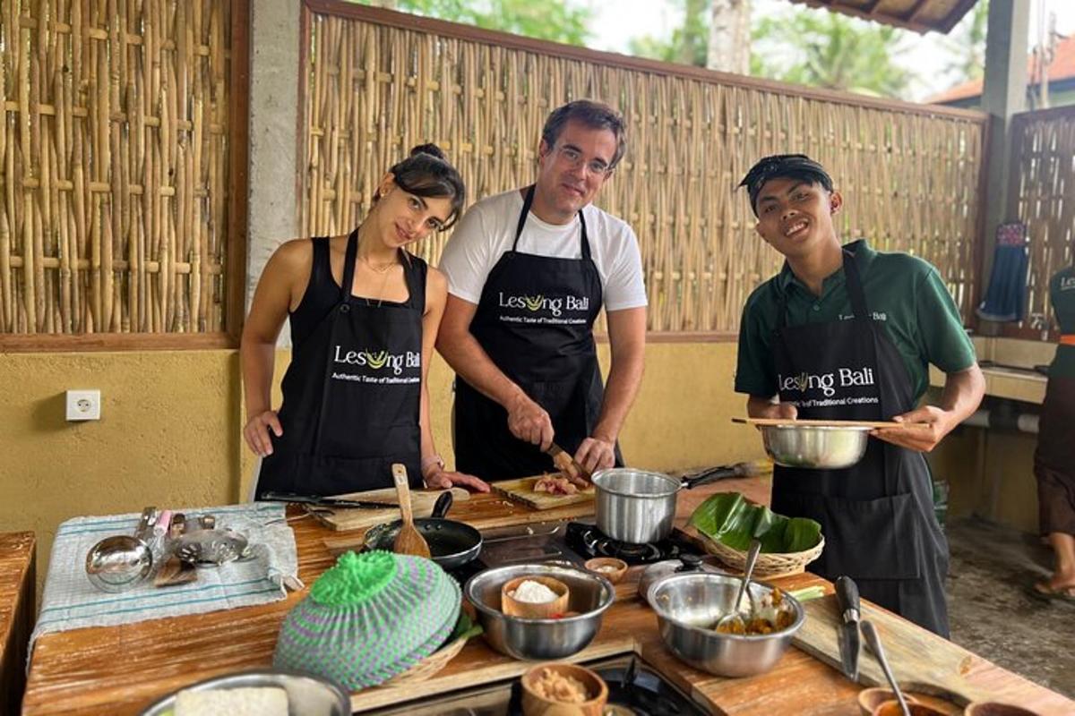 a group of three people in a kitchen preparing food