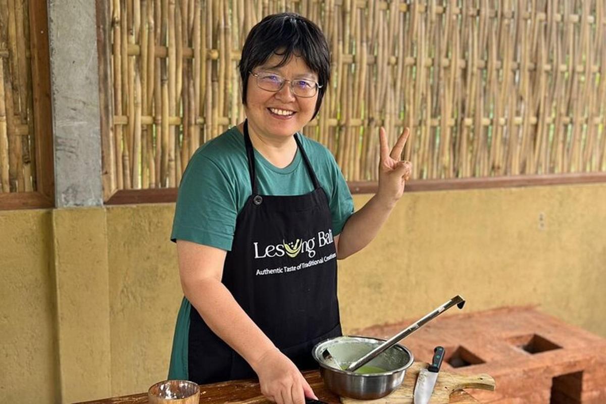 a woman in an apron standing in a kitchen