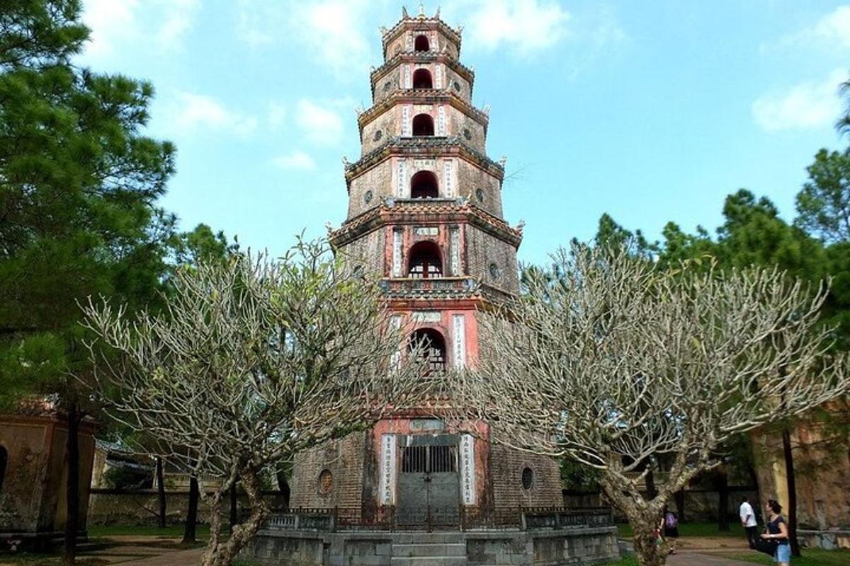 un vecchio edificio con una torre dell'orologio in un parco