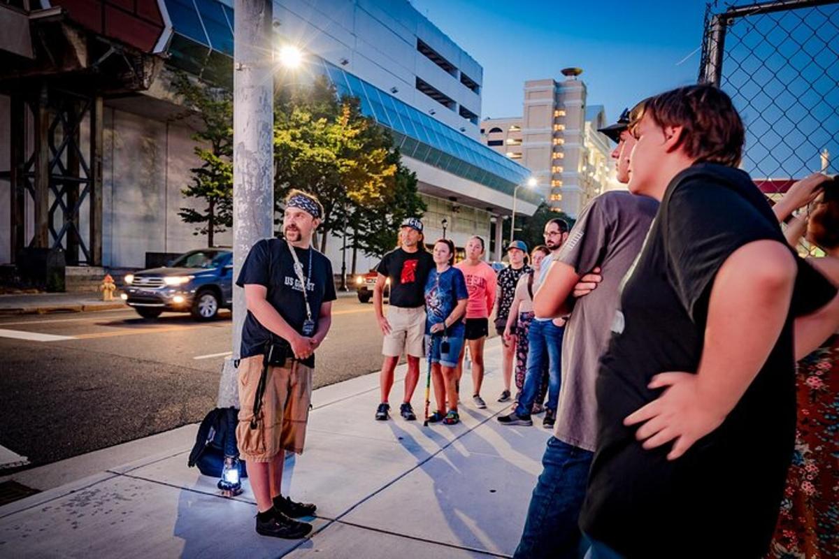 a group of people standing on a sidewalk near a street