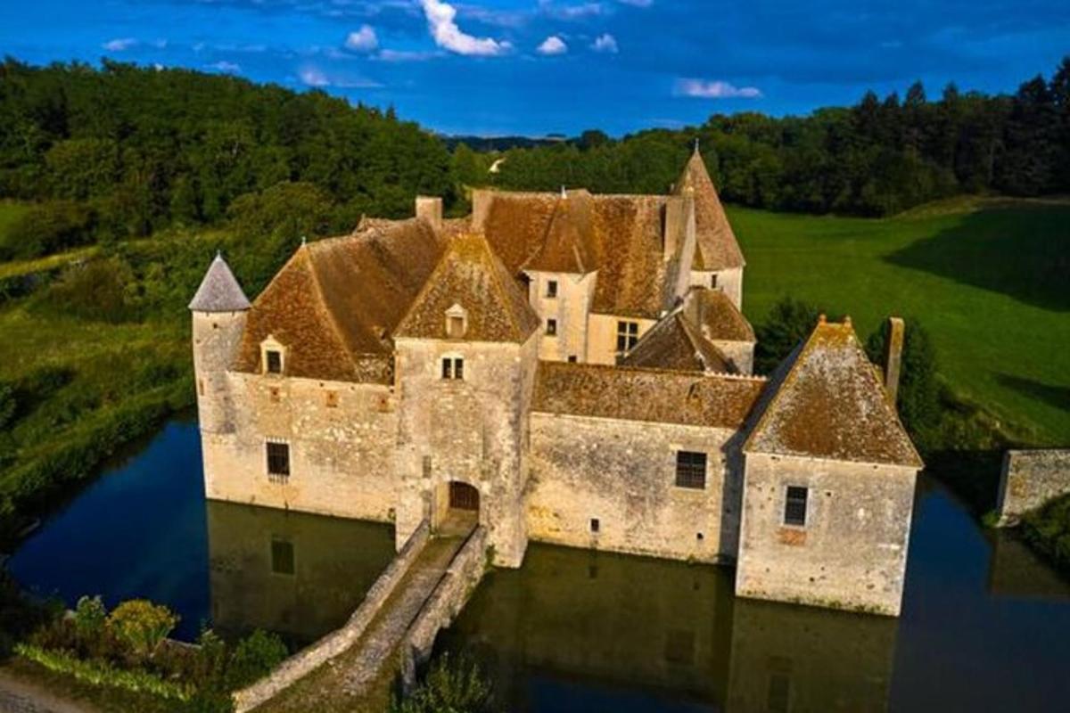 an aerial view of a castle in the water