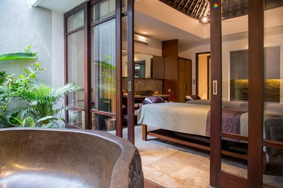 a bedroom with a bed and a living room