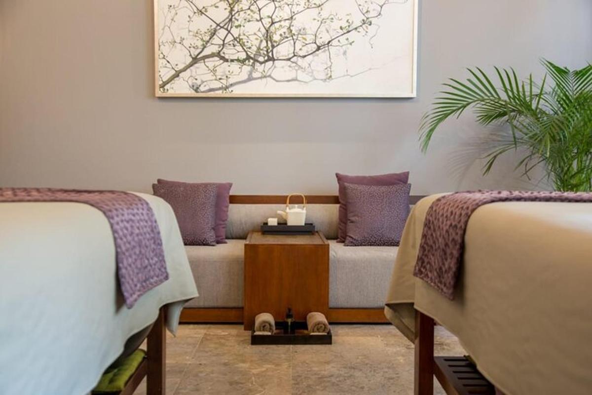 a living room with two beds and a couch