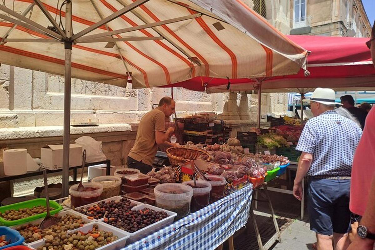 a group of people standing at an outdoor market