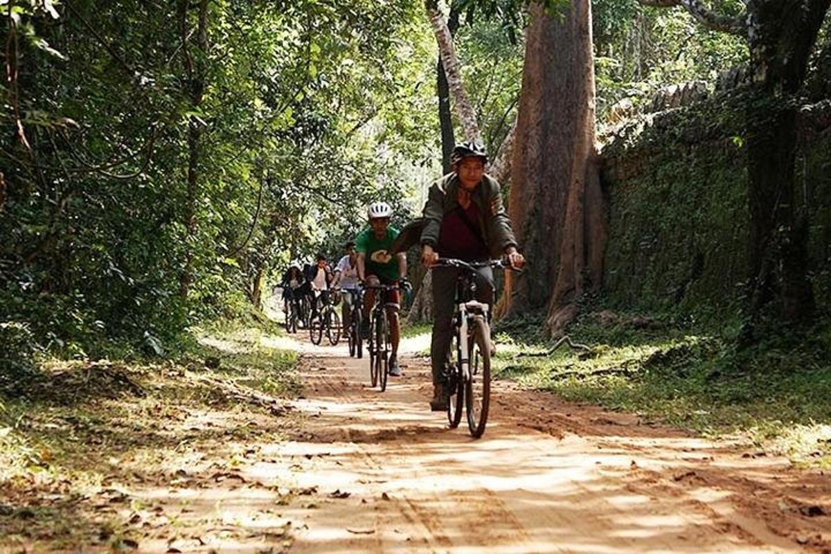 sekumpulan orang menunggang basikal melalui jalan tanah