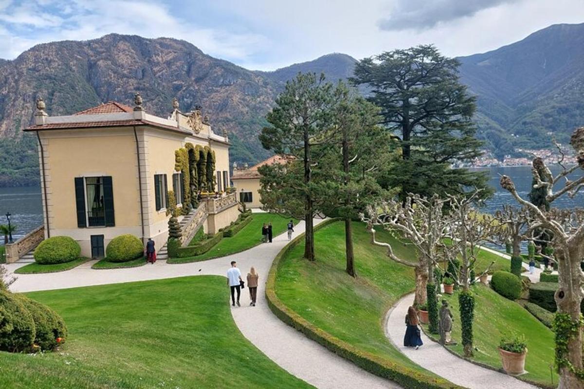 people walking on a path in front of a building