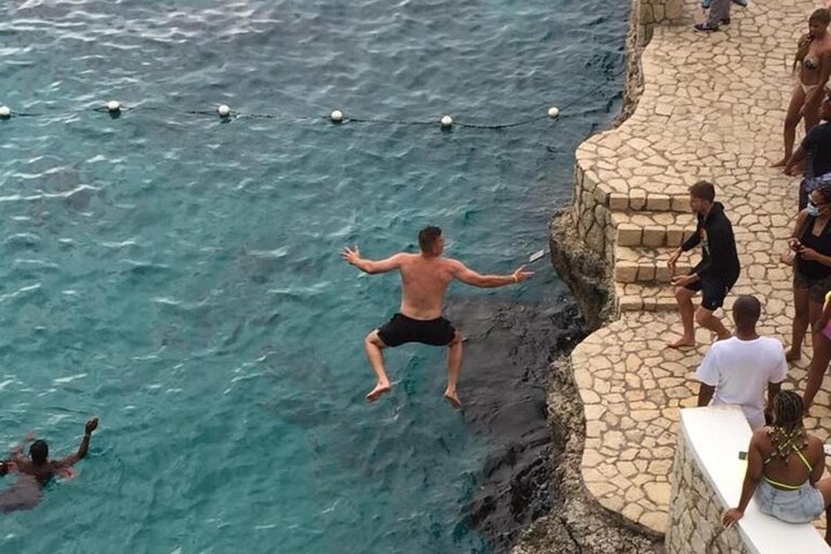 a man jumping into the water in the ocean