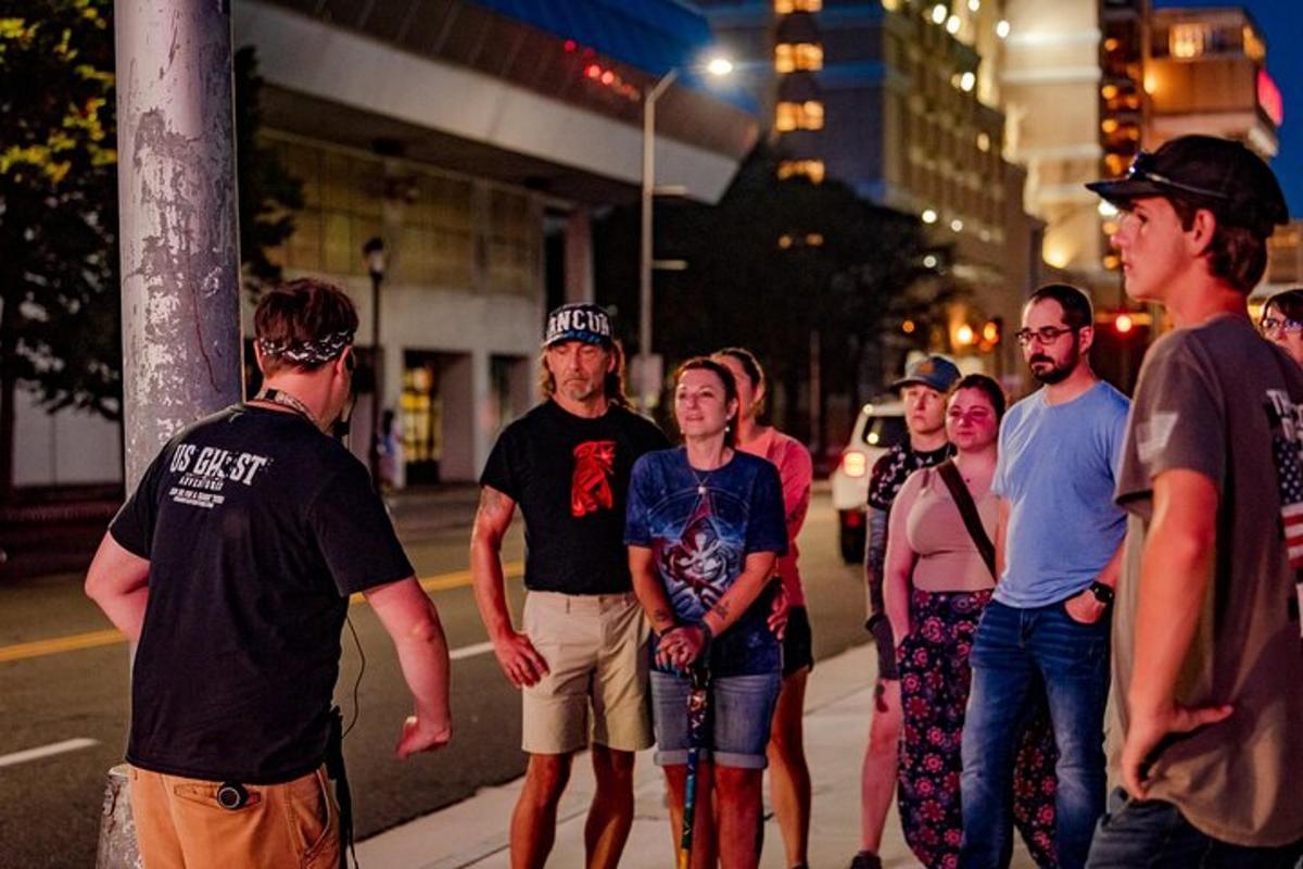a group of people standing on a street at night