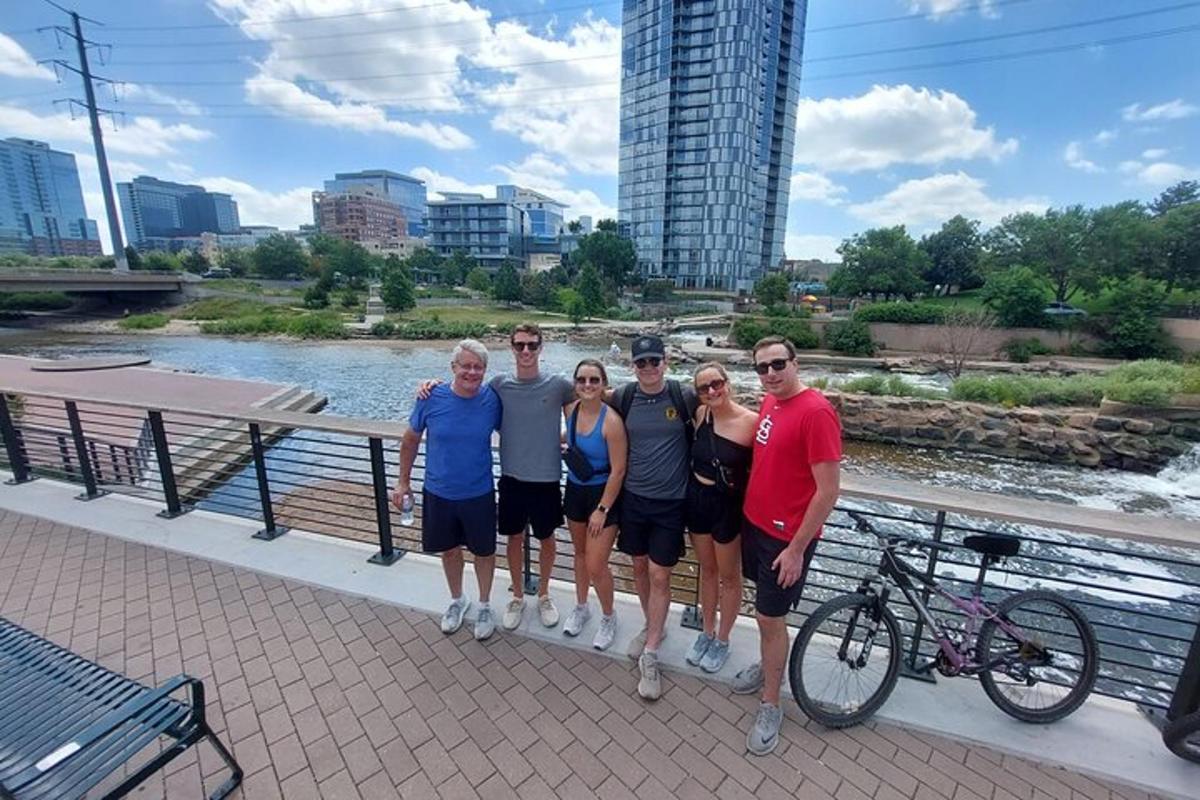 a group of people posing for a picture on a bridge