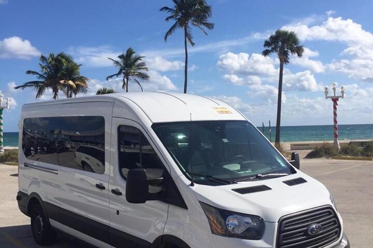 a white van parked in a parking lot next to the ocean