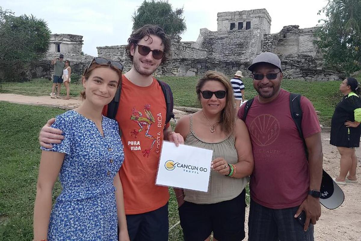 a group of people posing for a picture in front of a building