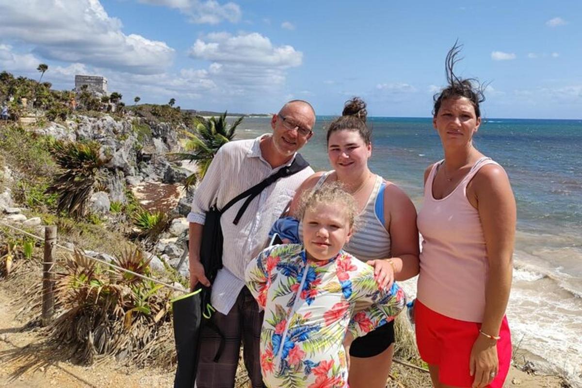 a family posing for a picture on the beach