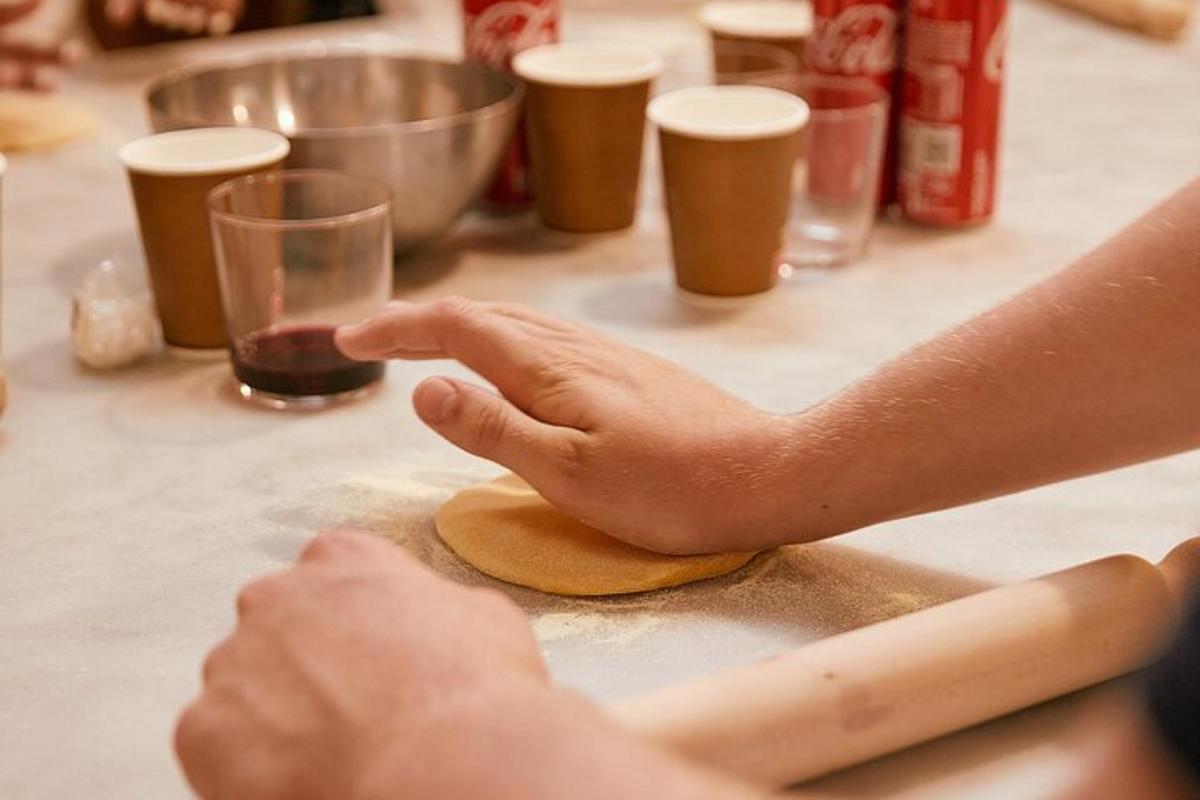 una persona sta impastando un impasto su un tavolo con un bicchiere
