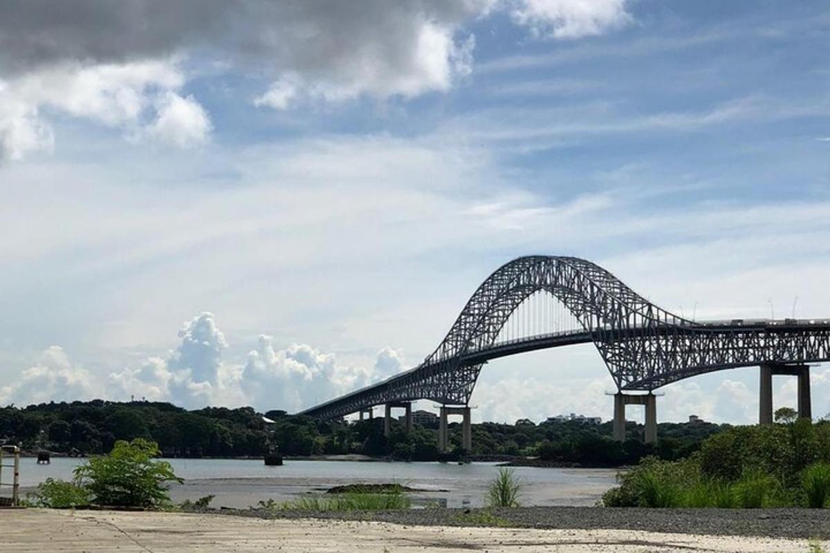 a large bridge over a river with a cloudy sky
