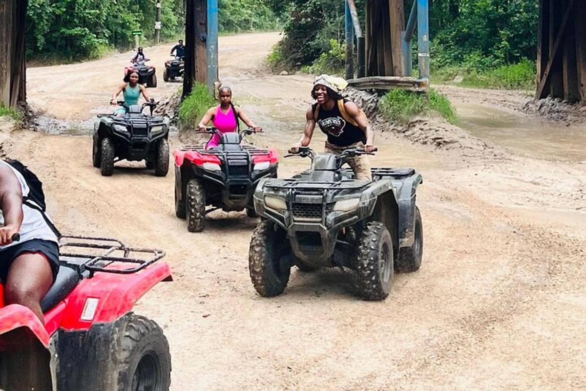 a group of people riding atvs on a dirt road