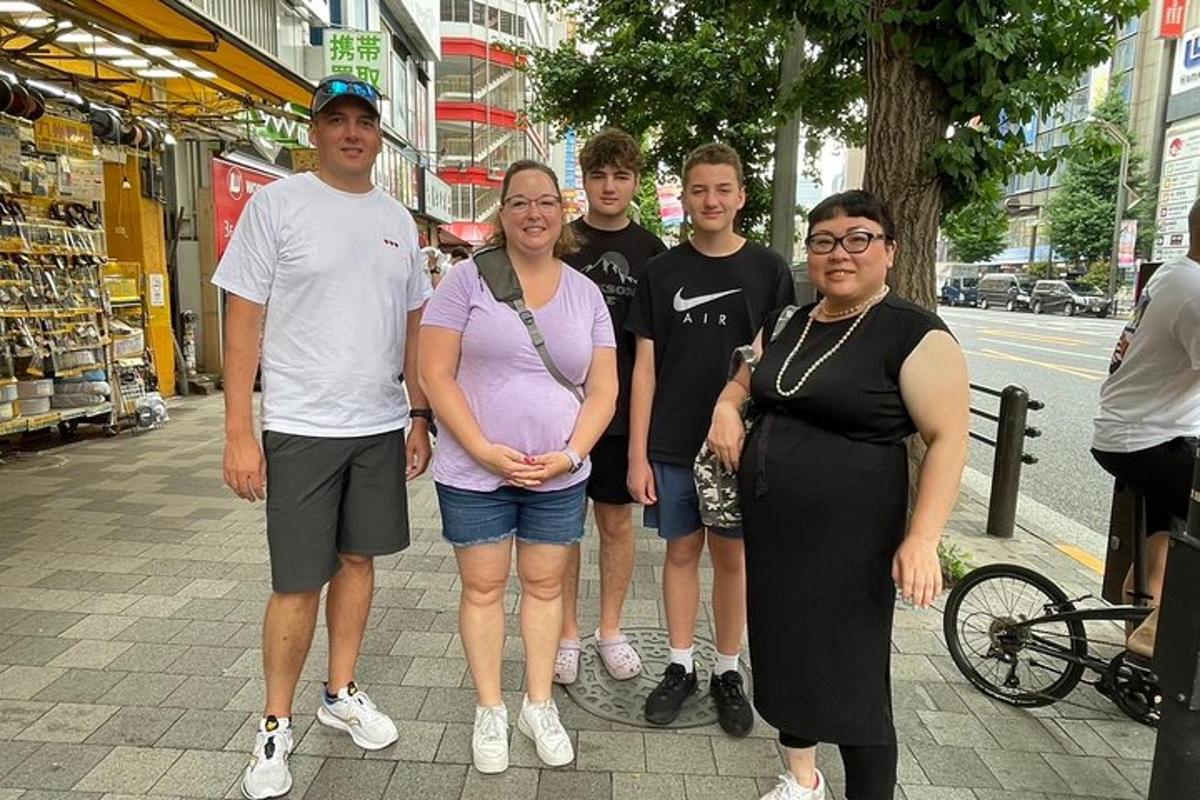 a group of people posing for a picture on a sidewalk