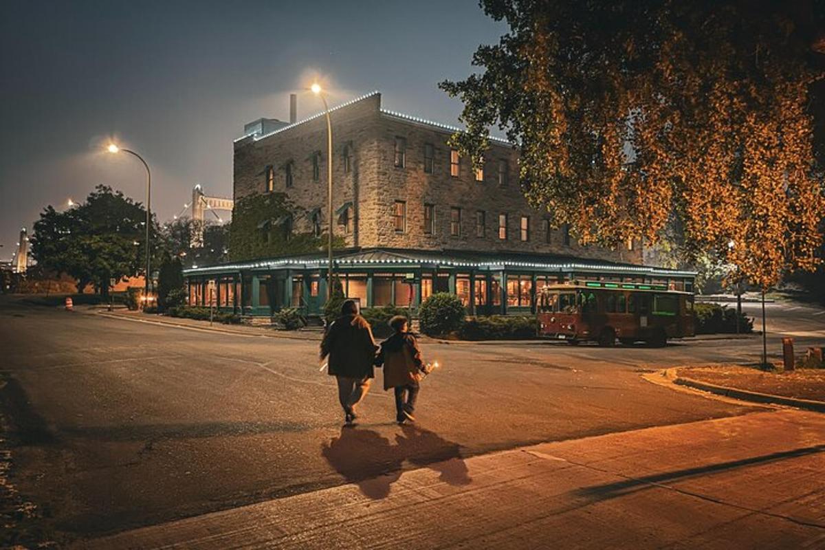 two people walking down a street in front of a building