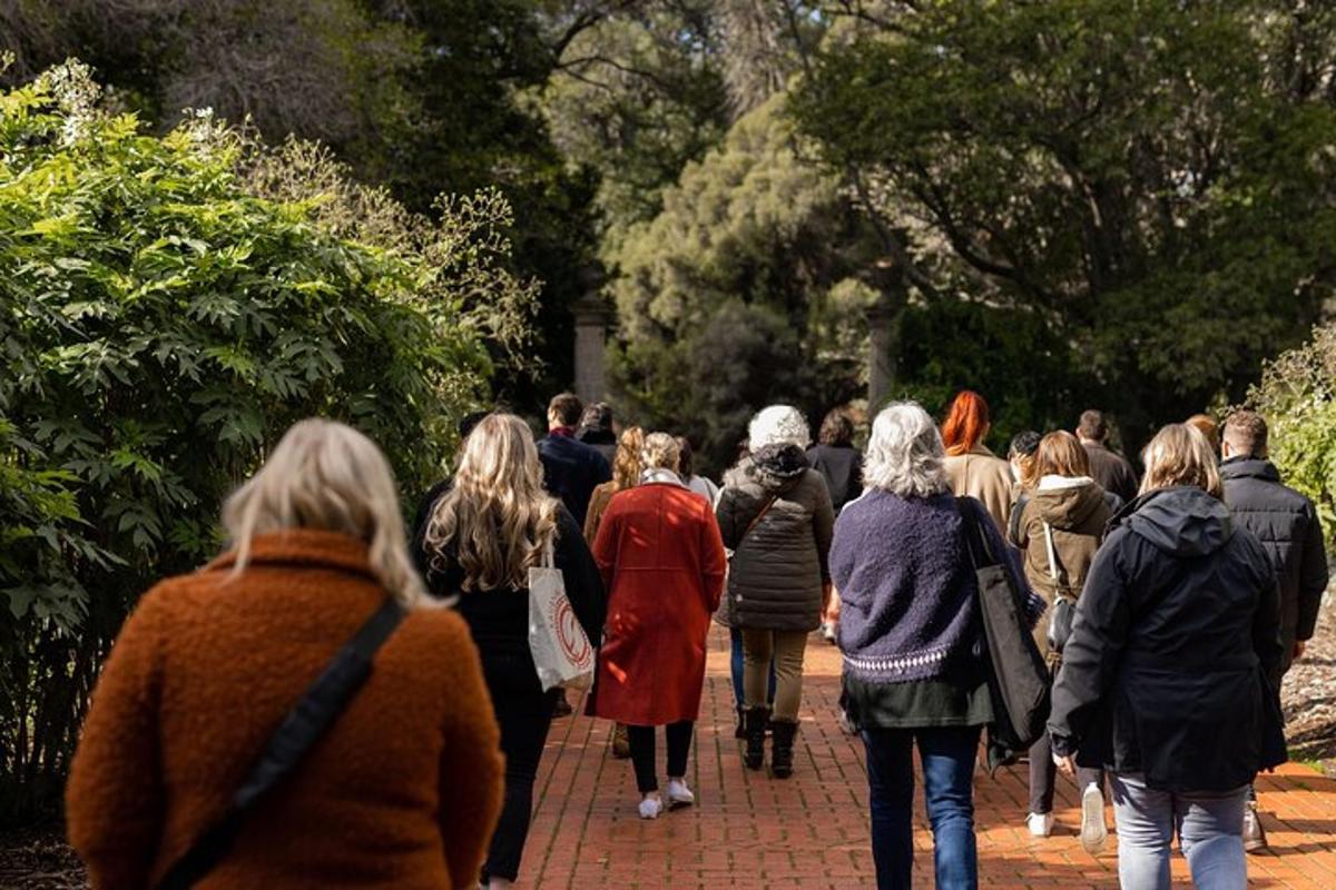 a group of people walking down a sidewalk