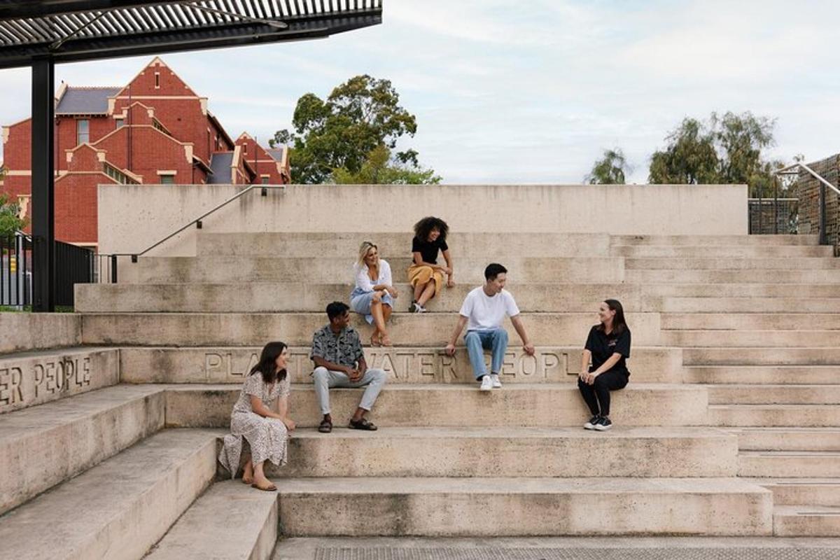 a group of people sitting on concrete steps