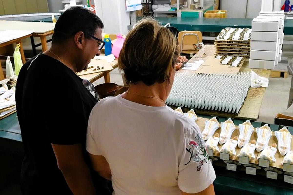 a man and a woman standing in a store selling shoes